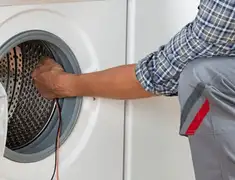 Dryer repair technician diagnosing and servicing a clothes dryer in Pittsburgh, PA
