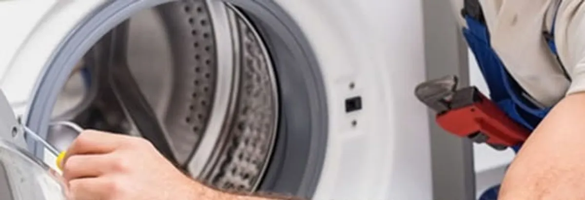 Appliance technician repairing a clothes dryer drum and internal parts in Pittsburgh, PA