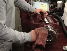Vacuum repair technician cleaning and servicing a vacuum motor in Pittsburgh, PA